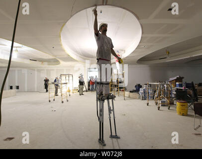 Drywallers work on the new fiction room during a walking tour of the construction being done at the St. Louis Public Library in St. Louis on January 6, 2012. The central library is undergoing a $70 million restoration and modernization project which first opened to the public in 1912. The library is expected to reopen in November.    UPI/Bill Greenblatt Stock Photo