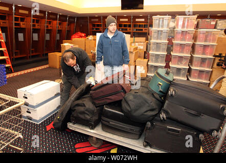 St. Louis Cardinals clubhouse attendent Andy Bollier pushes a cart