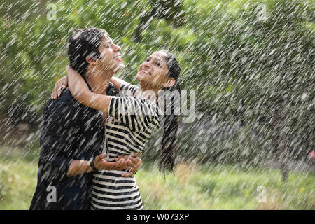 Indian couple romancing in the rain Stock Photo