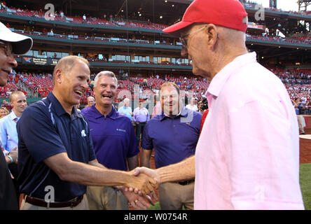 Former University of Missouri head basketball coach Norm Stewart (R) shakes hands with Michigan head basketball coach John Beilein as Kansas State head basketball coach Bruce Weber (R) looks on after a Coaches vs Cancer ceremonial first pitch before the New York Mets-St. Louis Cardinals baseball game at Busch Stadium in St. Louis on September 4, 2012.     UPI/Bill Greenblatt Stock Photo