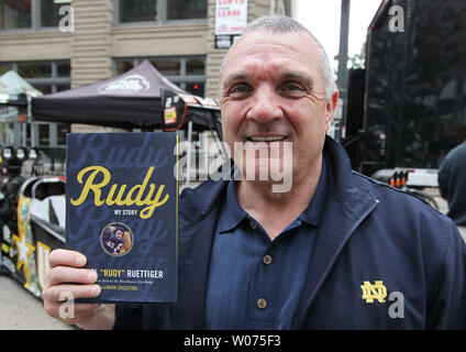 Former Notre Dame football player Eugene 'Rudy' Ruettiger shows off his book after an interview promoting the book 'Rudy, My Story,' in St. Louis on September 27, 2012. Ruettiger, who was dyslexic, had a dream to play for the Notre Dame Fighting Irish football team and head coach Ara Parseghian encouraged Ruettiger to become a walk-on player.  In Ruettiger's last opportunity to play for Notre Dame at home, then head coach Dan Devine put him into a game as defensive end against Georgia Tech on November 8, 1975.  Ruettiger, played three downs, recorded a sack of the quarterback and was carried o Stock Photo