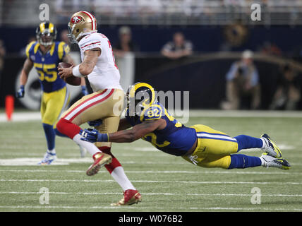St. Louis Rams Eugene Sims reaches out to slow San Francisco 49'ers quarterback Colin Kaepernick in the first quarter at the Edward Jones Dome in St. Louis on December 2, 2012.     UPI/Bill Greenblatt Stock Photo