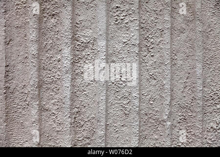 Gray dull background with a rough stone texture with vertical stripes of beige color on the wall of an old antique building. Substrate under the text Stock Photo