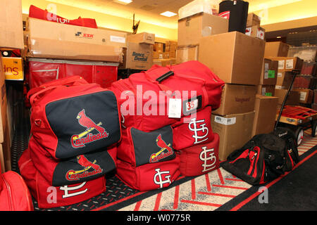 St. Louis Cardinals clubhouse attendant Nate Pfitzer moves boxes and luggage  from the team locker room at Busch Stadium in St. Louis to a waiting truck  as they prepare to leave for