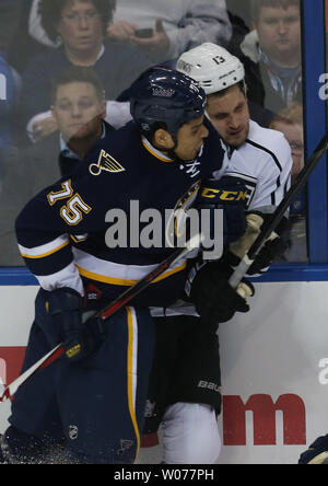 St. Louis Blues Ryan Reeves (75) is held back by linesman Matt ...