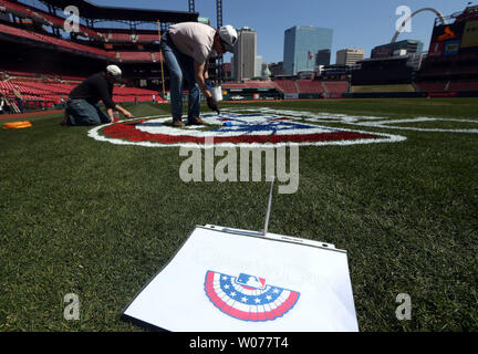 Painters from Warren Sign Company prepare new stcikers on the left field  wall of retired numbers for opening day at Busch Stadium in St. Louis in  April 5, 2013. The St. Louis