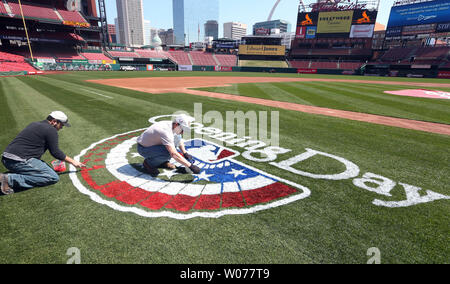 Painters from Warren Sign Company prepare new stcikers on the left field  wall of retired numbers for opening day at Busch Stadium in St. Louis in  April 5, 2013. The St. Louis