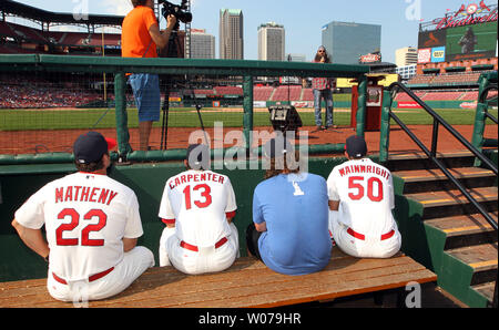 St. Louis Cardinals Matt Carpenter (L) stands with manager Mike Matheny  after receiving the 2013 Heart and Hustle Award before a game against the  Atlanta Braves at Busch Stadium in St. Louis