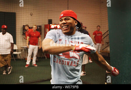 Rapper and St. Louis native Nelly, tries his hand at batting practice  before the Los Angeles Dodgers-St. Louis Cardinals baseball game at Busch  Stadium in St. Louis on August 6, 2013. The