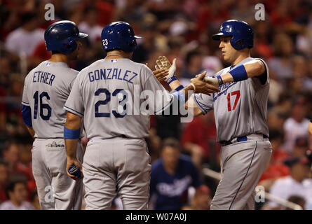 Los Angeles Dodgers A.J . Ellis (17) is congratulated at home plate by teammates Andre Ethier and Adrian Gonzalez after hitting a three run home run in the fifth inning against the St. Louis Cardinals at Busch Stadium in St. Louis on August 8, 2013.UPI/Bill Greenblatt Stock Photo