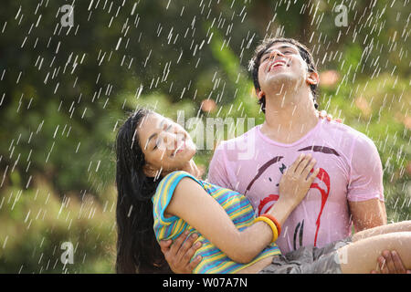 Indian couple romancing in the rain Stock Photo - Alamy