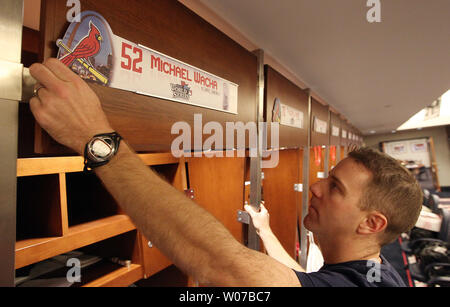 Clubhouse worker Mark Walsh places bats and equiptment into