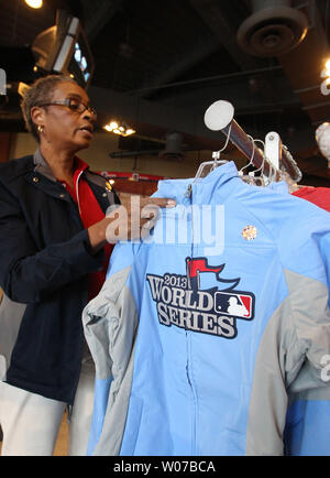 Busch Stadium Team Store manager Marceline Brooks, puts up a new