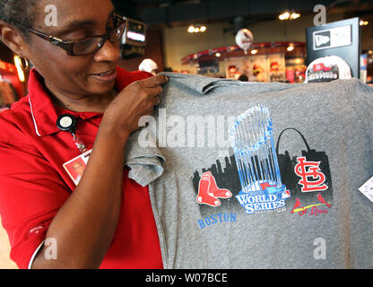 Busch Stadium Team Store manager Marceline Brooks, puts up a new