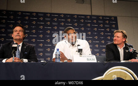 St. Louis Rams rookie Michael Sam listens in as he meets with reporters at Rams Park in Earth City, Missouri on May 13, 2014. Sam, the first openly gay player was drafted by the Rams in the 2014 draft. With Sam is head coach Jeff Fisher (L) general manager Les Sneed.   UPI/Bill Greenblatt Stock Photo