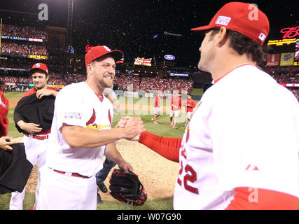 St. Louis Cardinals President Bill DeWitt III (R) points out the highlights  of the team's new uniform on pitcher Trevor Rosenthal at Busch Stadium in St.  Louis on November 16, 2012. For