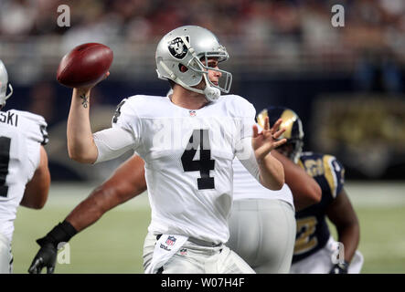 Oakland Raiders quarterback Derek Carr throws the football in the