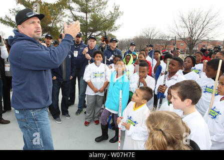 Terrance Williams, Dallas Cowboys wide receiver, coaches children during a  youth football camp June 26, 2017, at Joint Base San Antonio-Randolph.  JBSA-Randolph was one of the 11 military communities selected to host