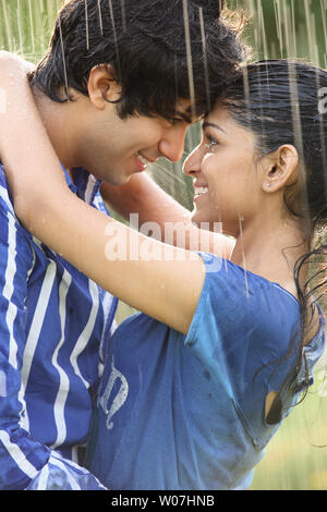 Indian couple romancing in the rain Stock Photo - Alamy