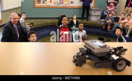Missouri Governor Jay Nixon sits with school children from Marion Elementary School as they watch a demonstration of a robotic car while discussing the school's "Lead the Way," program in Overland, Missouri on January 22, 2015. Lead the Way is a project-based program that provides hands-on learning experiences for students in the areas of Science, Technology, Engineering and Math (STEM).  Photo by Bill Greenblatt/UPI Stock Photo