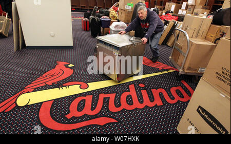 Clubhouse worker Mark Walsh places bats and equiptment into lockers in the  clubhouse at the new Busch Stadium in St. Louis on April 3, 2006. The  Cardinals will play in their new