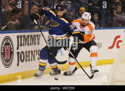 St. Louis Blues Chris Porter and Philadelphia Flyers Mark Streit battle for the puck in the first period at the Scottrade Center in St. Louis on March 12, 2015.   Photo by Bill Greenblatt/UPI Stock Photo