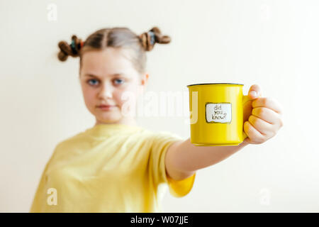 A girl with a yellow ring in her hand, on which was written Did you know Stock Photo