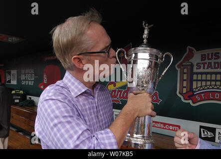 Fox broadcaster Joe Buck gives the U.S. Open Championship Trophy a kiss in the dugout before the Los Angeles Dodgers-St. Louis Cardinals baseball game at Busch Stadium in St. Louis on May 30, 2015.Fox Sports willl begins its first year as the United States Golf Association's principal media partner when they broadcast the 2015 U.S. Open at Chambers Bay in June.  Photo by Bill Greenblatt/UPI Stock Photo