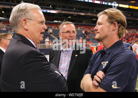 Missouri Governor Jay Nixon (L) talks with Kansas City Chiefs General Manager John Dorsey and St. Louis Rams General Manager Les Sneed (R) before the start of the annual Governor's Cup at the Edward Jones Dome in St. Louis on September 3, 2015.  Photo by Bill Greenblatt/UPI Stock Photo