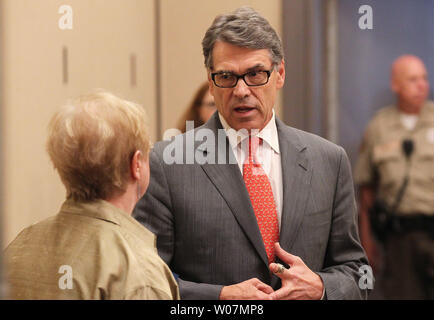 Texas Governor and Presidential candidate Rick Perry talks with a supporter in a hold room before delivering his remarks at the Eagle Council forum in St. Louis on September 11, 2015. Several Republican candidates attended the weekend long meeting.  Photo by Bill Greenblatt/UPI Stock Photo