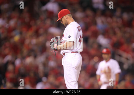 St. Louis Cardinals President Bill DeWitt III (R) points out the highlights  of the team's new uniform on pitcher Trevor Rosenthal at Busch Stadium in St.  Louis on November 16, 2012. For