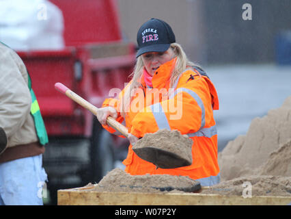 Volunteer Theresa Arnett fills sandbags as three days of steady rains have caused the Meramec River to rise to near record levels in Eureka, Missouri on December 28, 2015. Missouri Governor Jay Nixon has declared a state of emergency with over 125 roads flooded or closed and 10 deaths due to the flooding statewide. Photo by Bill Greenblatt/UPI Stock Photo