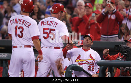 St. Louis Cardinals Matt Carpenter (L) stands with manager Mike Matheny  after receiving the 2013 Heart and Hustle Award before a game against the  Atlanta Braves at Busch Stadium in St. Louis