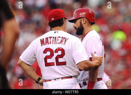 St. Louis Cardinals Matt Carpenter (L) stands with manager Mike Matheny  after receiving the 2013 Heart and Hustle Award before a game against the  Atlanta Braves at Busch Stadium in St. Louis