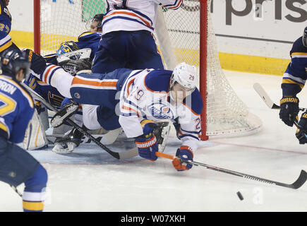 Edmonton Oilers Leon Draisaitl falls over St. Louis Blues goaltender Jake Allen as he goes for the puck in the third period at the Scottrade Center in St. Louis on December 19, 2016. Edmonton won the game 3-2 in overtime.   Photo by BIll Greenblatt/UPI Stock Photo