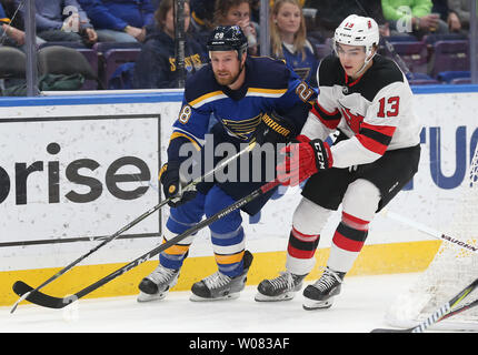 New Jersey Devils' Nico Hischier, right, of Switzerland, moves the puck ...