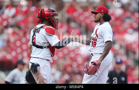 St. Louis Cardinals President Bill DeWitt III (R) points out the highlights  of the team's new uniform on pitcher Trevor Rosenthal at Busch Stadium in St.  Louis on November 16, 2012. For