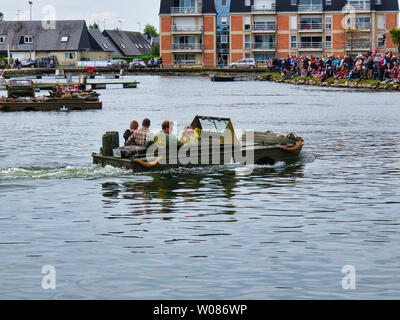 CARENTAN, FRANCE - June 06, 2019. Special forces men in camouflage uniforms in a landing craft during an amphibious assault demonstration. Diversionar Stock Photo