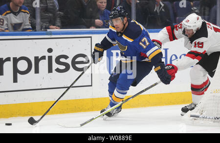 St. Louis Blues Jaden Schwartz fights off New Jersey Devils Travis Zajac behind the net in the first period at the Enterprise Center in St. Louis on February 12, 2019. Photo by Bill Greenblatt/UPI Stock Photo