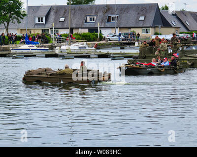 CARENTAN, FRANCE - June 06, 2019. Special forces men in camouflage uniforms in a landing craft during an amphibious assault demonstration. Diversionar Stock Photo