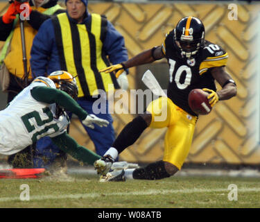 Seattle Seahawks running back Shaun Alexander (37) is tacked by Green Bay  Packers safety Atari Bigby (20) for a 1-yard loss during the first quarter  of the NFC Divisional Playoff at Lambeau