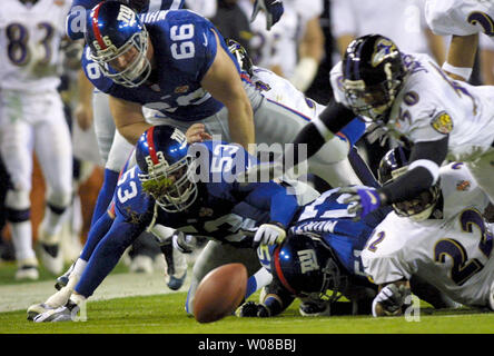 SPB2001012850 - 28 JANUARY 2001 - TAMPA BAY, FLORIDA, USA: New York Giants Brandon Short (53), Jason Whittle (66) and Pete Monty (51) battle Baltimore Ravens' Brad Jackson (50) and Duane Starks (22) for a fumble recovery during Super Bowl XXXV in Tampa Bay, Florida on January 28, 2001.   bc/tw/Todd Warshaw     UPI Stock Photo