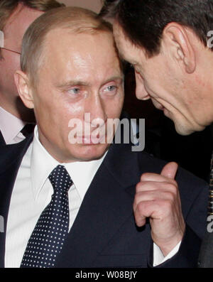 Russian President Vladimir Putin talks to Deputy Prime Minister Alexander Zhukov at the opening of a new high-tech building for the archives the Russian State History Archives in St. Petersburg, December 23, 2005. (UPI Photo/Anatoli Zhdanov) Stock Photo