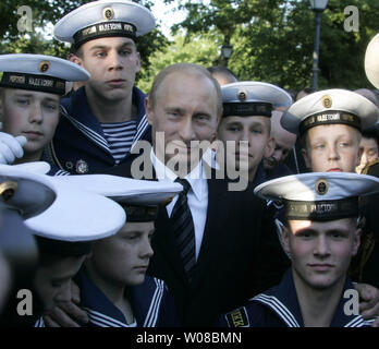 Russian President Vladimir Putin and students of a naval boarding school pose for a photo after a ceremony of the unveiling of the monument to late Anatoly Sobchak, St. Petersburg's Mayor, in St. Petersburg on June 12, 2006. Putin was an aide to Sobchak from1994 to 1996. (UPI Photo/Anatoli Zhdanov) Stock Photo