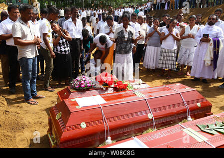 Relatives of victims weep during the funeral of their family members killed in the Easter Sunday bombings in Colombo, Sri Lanka, April 23, 2019. More than 300 people were killed in suicide bomb blasts on churches and hotels. It was the South Asian island nation's deadliest violence in a decade. Sri Lanka police arrested 40 suspects in the wake of a state of emergency.        Photo by Perera Sameera/UPI Stock Photo