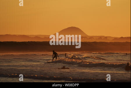 Surfers on Belhaven beach near Dunbar in the Scottish Borders after the sun set. Stock Photo