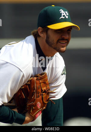 Oakland Athletics pitcher Barry Zito looks at the scoreboard after