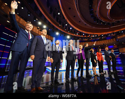 Miami, United States. 26th June, 2019. Democratic presidential candidates (from L) Bill De Blasio, Tim Ryan, Julian Castro, Cory Booker, Elizabeth Warren, Beto O'Rourke, Amy Klobuchar, Tulsi Gabbard, Jay Inslee, and John Delaney take the stage at the start of the first Democratic presidential primary debate for the 2020 election on June 26, 2019 at the Knight Concert Hall at the Adrienne Arsht Center for the Performing Arts in Miami, Florida. Credit: Paul Hennessy/Alamy Live News Stock Photo