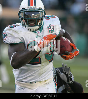 Former Buffalo Bills player Ruben Brown waves the flag against the Miami  Dolphins during the first quarter of an NFL football game in Orchard Park,  N.Y., Sunday, Dec. 18, 2011. (AP Photo/David