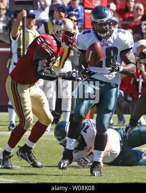 Philadelphia Eagles' Michael Lewis (32) and Ike Reese tackle Carolina  Panthers' DeShaun Foster causing him to fumble the ball in the second  quarter during the NFC championship game Sunday, Jan. 18, 2004